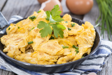 Scrambled Eggs with fresh eggs and herbsの写真素材