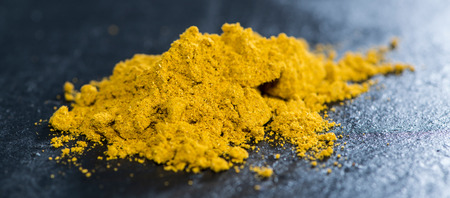 Small heap of Curry Powder on dark backgroundの写真素材