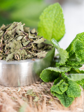Bowl with dried Mint on vintage wooden backgroundの写真素材