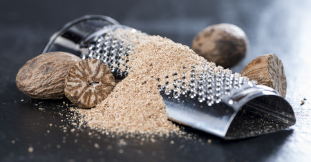 Small grater with some fresh Nutmegs (close-up shot)の写真素材