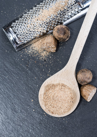 Small grater with some fresh Nutmegs (close-up shot)の写真素材