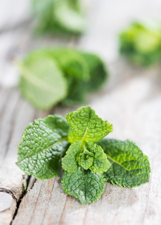 Fresh Mint leaves on weathered wooden background