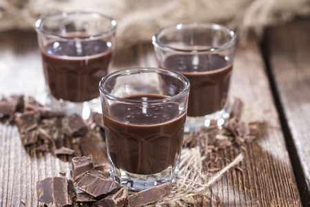Chocolate Liqueur (homemade) on a dark vintage wooden table