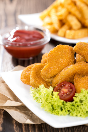 Portion of Chicken Nuggets with Chips (detailed close-up shot)の写真素材