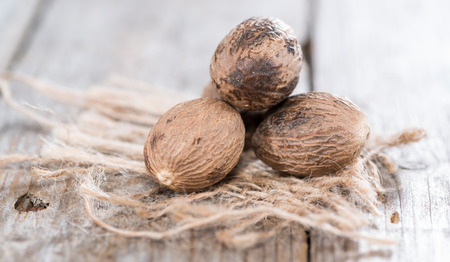 Some Nutmegs (close-up shot) on vintage backgroundの写真素材