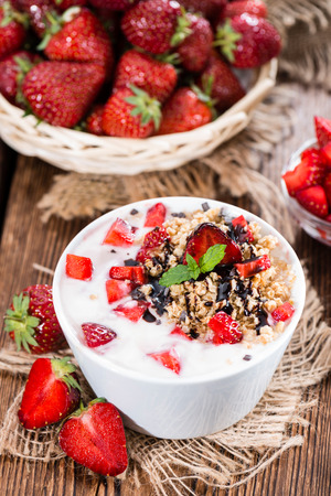 Strawberry Yogurt in a small bowl on wooden backgroundの写真素材