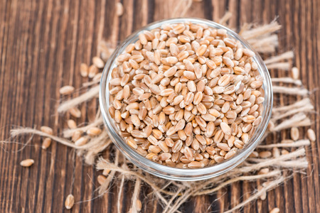 Wheat Grains on an old wooden table (detailed close-up shot)