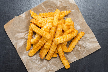 Portion of Chips on dark background (detailed close-up shot)