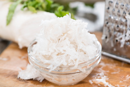 Fresh grated Horseradish on dark wooden backgroundの写真素材