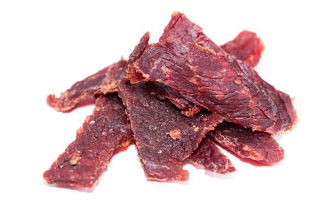 Portion of Beef Jerky (close-up shot) on pure white backgroundの写真素材