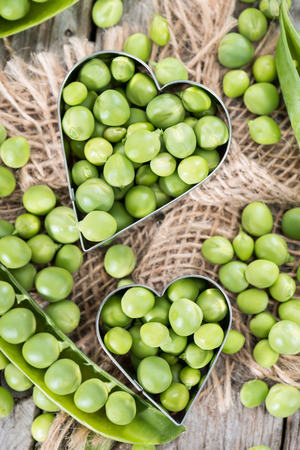 Portion of fresh harvested Peas on wooden backgroundの写真素材