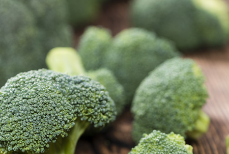 Portion of Raw Broccoli on dark wooden backgroundの写真素材