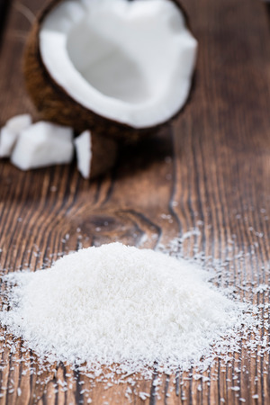 Grated Coconut (detailed close-up shot) on wooden backgroundの写真素材