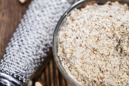 Portion of fresh grated Almonds on wooden backgroundの写真素材