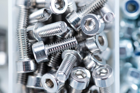 Different Screws and other Parts sorted in a box (close-up shot)