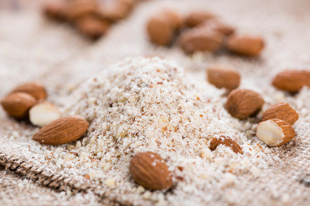 Portion of grated Almonds (detailed close-up shot on wooden background)の写真素材