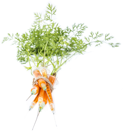 Carrot Injection (with green) isolated on white backgroundの写真素材