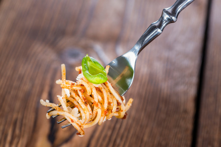 Portion of Spaghetti with Tomato Pesto, Basil and Parmesan Cheeseの写真素材