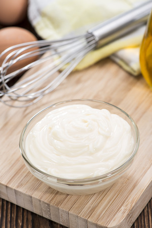 Fresh Mayonnaise (homemade) on an old wooden tableの写真素材