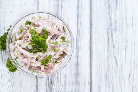 Meat Salad made with mayonnaise (close-up shot) on wooden backgroundの写真素材