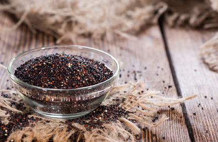 Small bowl with a portion of black Quinoa (close-up shot)の写真素材