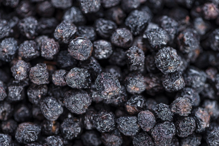 Heap of dried Chokeberries for use as background image or as textureの写真素材