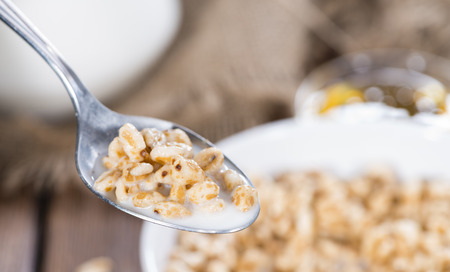 Portion of puffed wheat with milk and honeyの写真素材