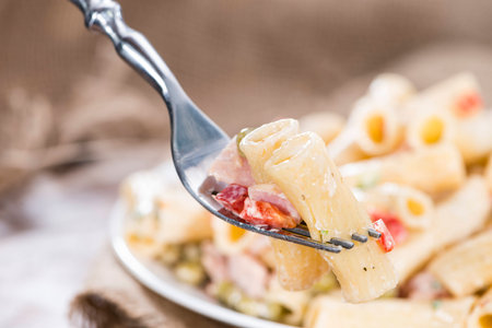 Pasta Salad with ham and mayonnaise on wooden backgroundの写真素材