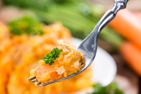 Portion of Carrot Stew (detailed close-up shot) on wooden backgroundの写真素材