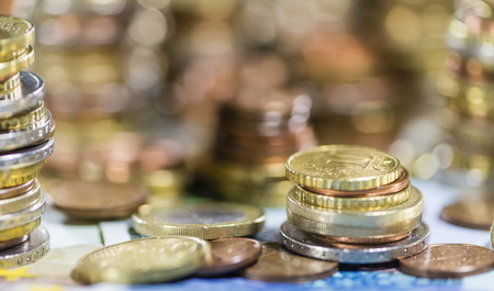 European Currency stacked Coins on Banknotes (close-up shot)