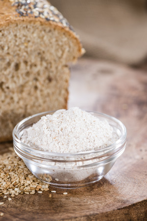 Loaf of bread (fresh baked) on rustic wooden backgroundの写真素材