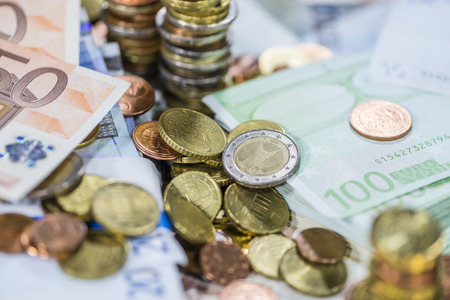 Euro Coins (as detailed close-up shot) on different Banknotes