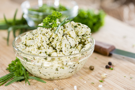 Portion of Herb Butter (with Chives, Basil, Oregano, Parsley and Rosemary) on rustic wooden backgroundの写真素材