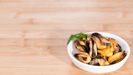 Grilled Mussels pickled in oil with different fresh herbsの写真素材