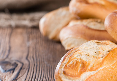 Homemade Buns (close-up shot) on dark vintage wooden background