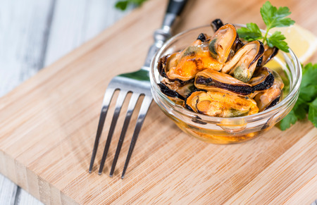Tasty Mussels pickled on oil with fresh herbs (close-up shot)の写真素材
