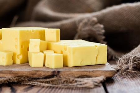 Portion of Cheese (close-up shot) on rustic wooden backgroundの写真素材