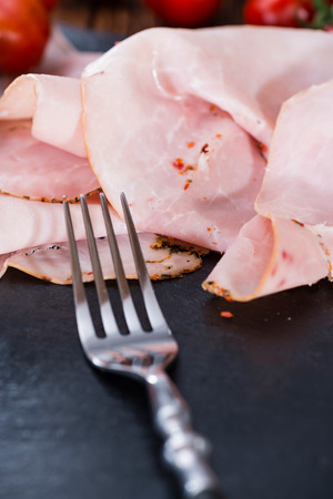 Ham with fresh herbs (close-up shot) on dark rustic backgroundの写真素材