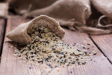 Rice (mixed with Wild Rice) on rustic wooden backgroundの写真素材