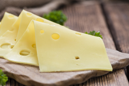 Sliced Cheese (detailed close-up shot) on rustic wooden backgroundの写真素材