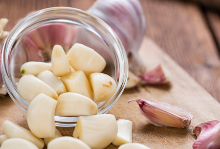 Peeled Garlic as detailed close-up shot on rustic wooden backgroundの写真素材