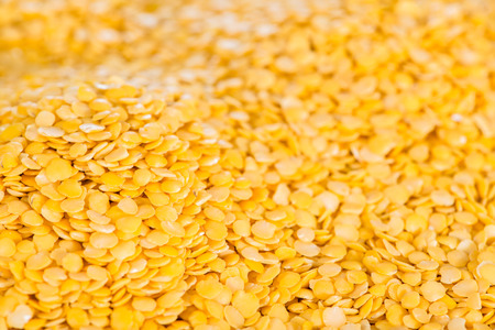Heap of yellow Lentils close-up shot for use as background image or as textureの写真素材