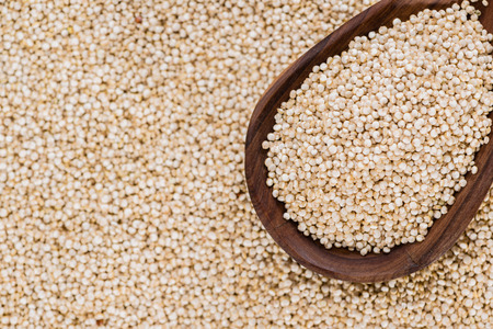 Portion of Quinoa (close-up shot) on a wooden spoon)の写真素材