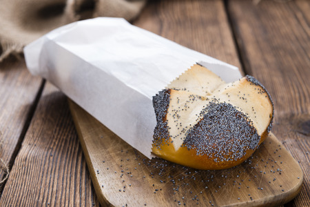 Homemade Pretzel Roll (with Poppyseed) on rustic wooden background
