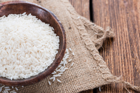 Portion of Rice on rustic wooden background (close-up shot)の写真素材