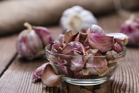 Garlic bulbs (detailed close-up shot) on wooden backgroundの写真素材
