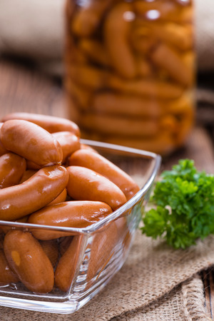 Portion of Mini Sausages (close-up shot) on rustic wooden backgroundの写真素材
