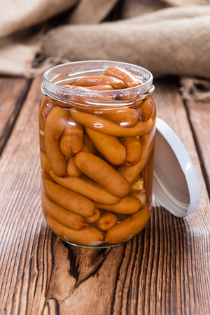 Party Food (Mini Sausages) on an old rustic wooden tableの写真素材