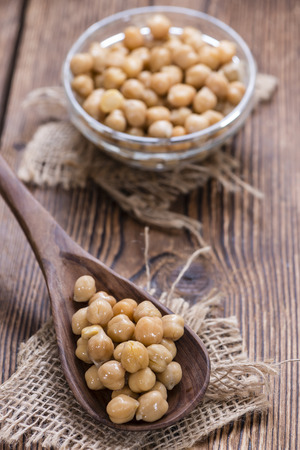 Portion of Chick Peas (Canned) on old wooden backgroundの写真素材