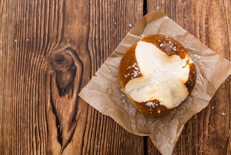 Salted Pretzel Roll (close-up shot) on wooden backgroundの写真素材